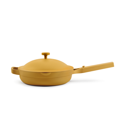 The Always Pan 2.0, a yellow nonstick frying pan with matching lid and long handle from a bestselling cookware line, is displayed against a plain white background.