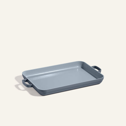 A rectangular gray Griddle Pan with a nonstick surface and two handles rests on a plain, light background.