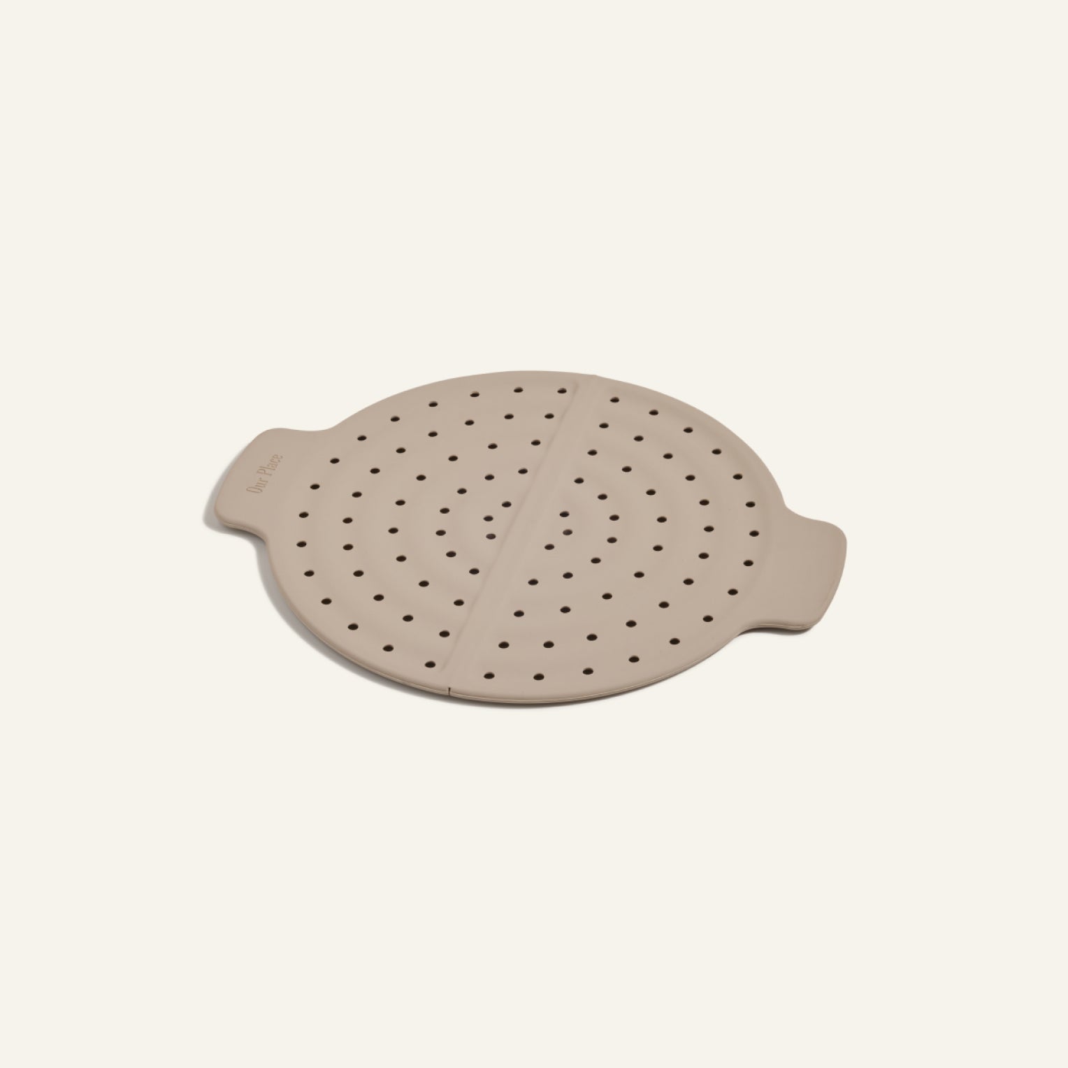 The Fearless Fry is a round, beige silicone steamer lid with side handles and ventilation holes for splatter prevention on your Always Pan, shown on a plain light background.