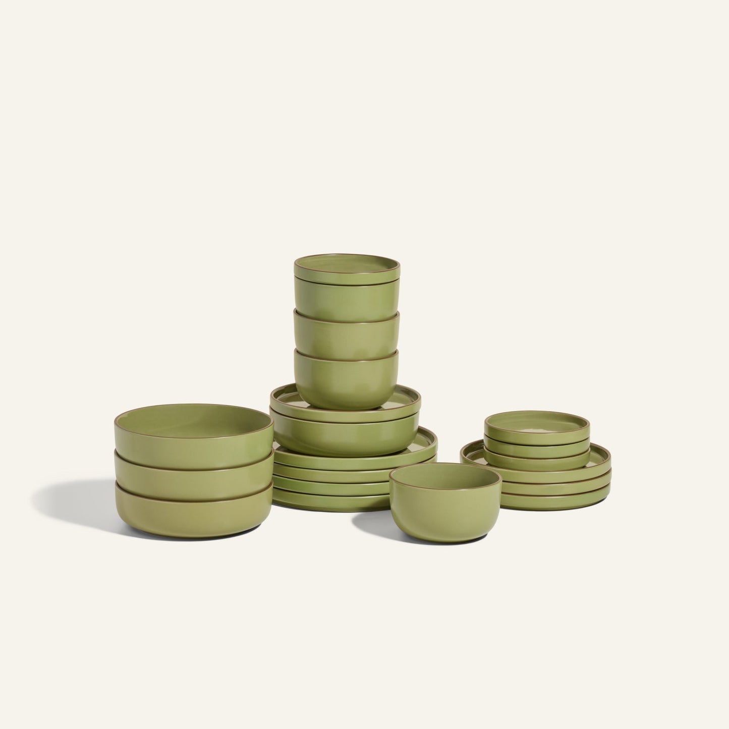The Classic Stacking Set is a 20-piece ceramic tableware collection featuring scratch-resistant green bowls and plates, neatly stacked on a plain light background.