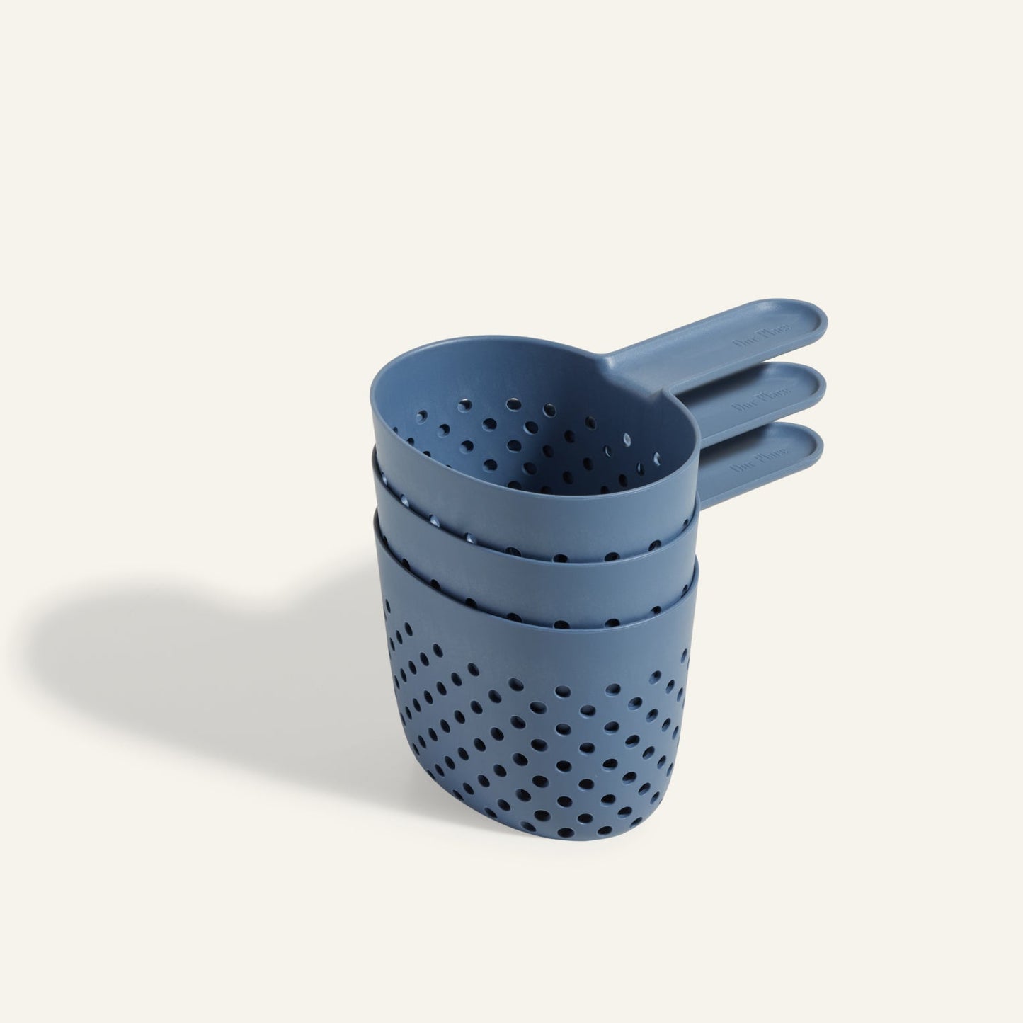 Three blue plastic Cooker Cups with holes, stacked on a light background—perfect for multi-cooking or pairing with your Perfect Pot to cook three dishes at once.