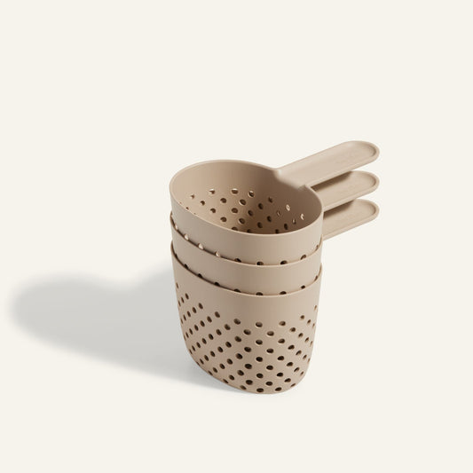 Three beige Cooker Cups, ideal for use with the Perfect Pot and multi-cooking, are stacked together on a light background.