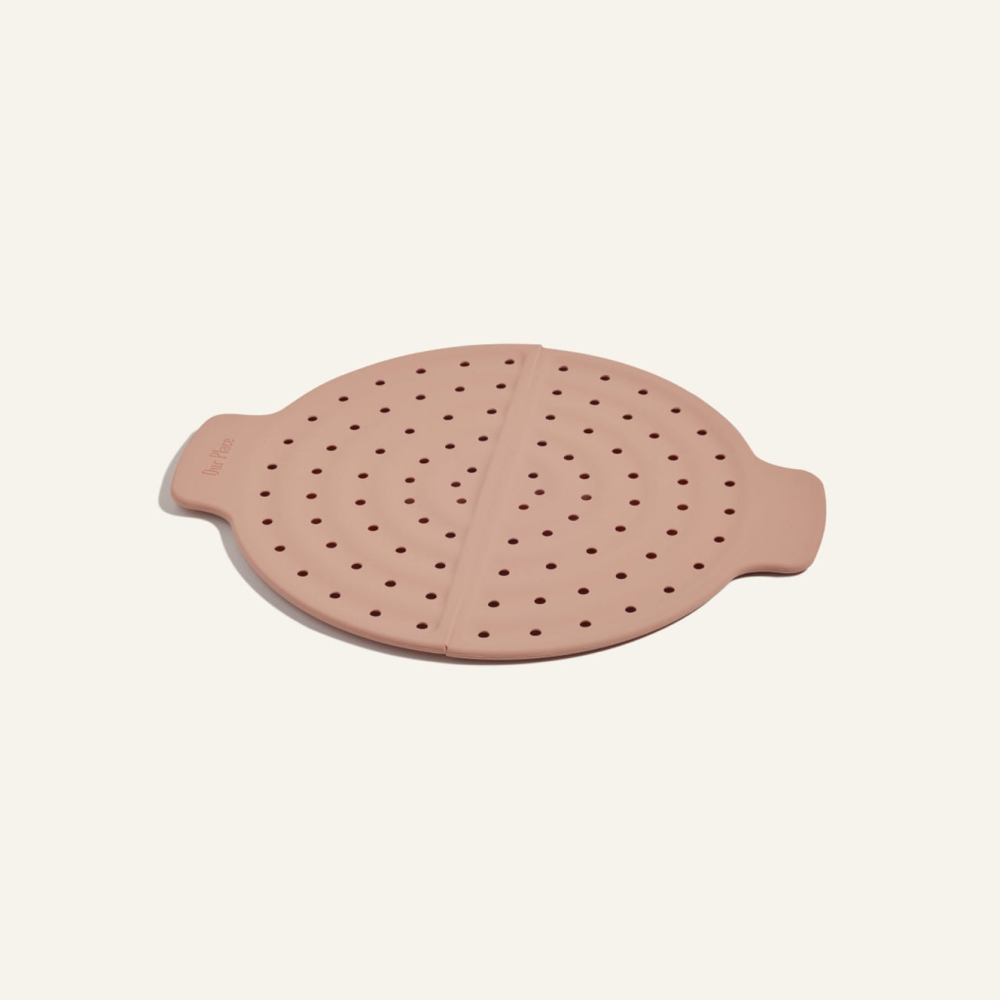 A pink, round silicone steam lid with side handles and evenly spaced holes for splatter prevention—ideal for use with your Fearless Fry pan.