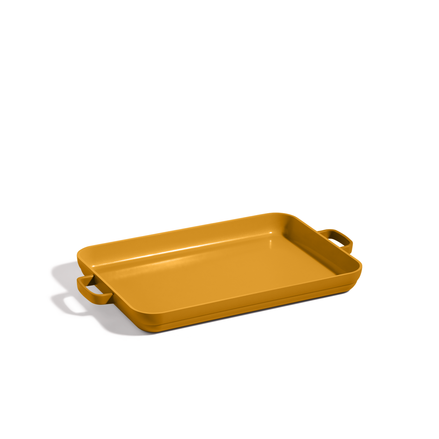 A rectangular mustard-yellow Griddle Pan with two side handles, resembling a nonstick sheet pan, is displayed against a plain white background.