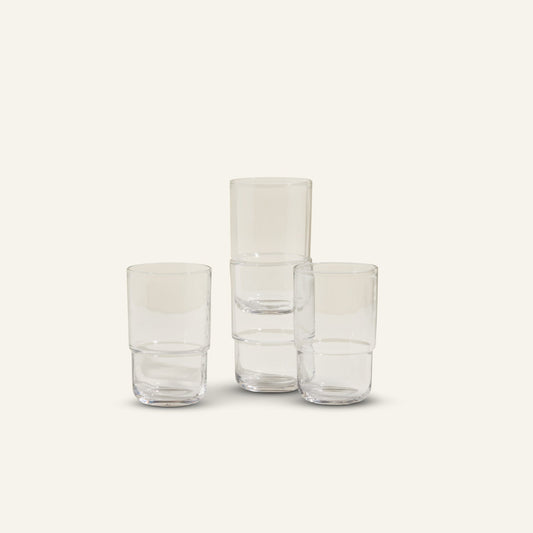 Four Tall Night + Day Glasses are arranged against a light background, with two 16 oz tumblers stacked and two standing separately in a minimalistic stackable display.