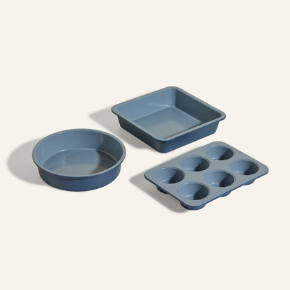 The Wonder Oven Baker’s Kit includes three blue non-toxic baking pans—a round, a square, and a six-cup muffin tin—arranged on a light background, perfect for your Wonder Oven.