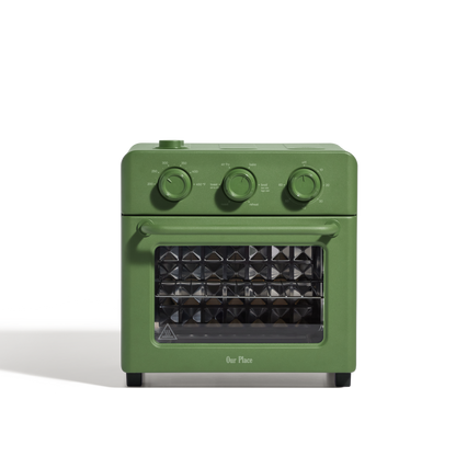 The AU - Wonder Oven is a compact green toaster oven with three dials on top and a glass door showcasing a diamond-patterned interior.