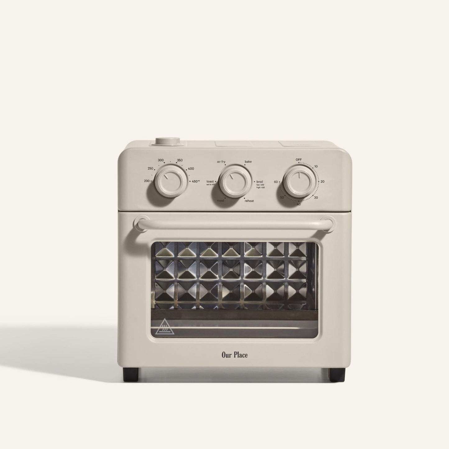 The AU - Wonder Oven is a beige toaster oven with three control dials, a glass door, and a diamond-patterned tray that doubles as an air fryer for versatile cooking.
