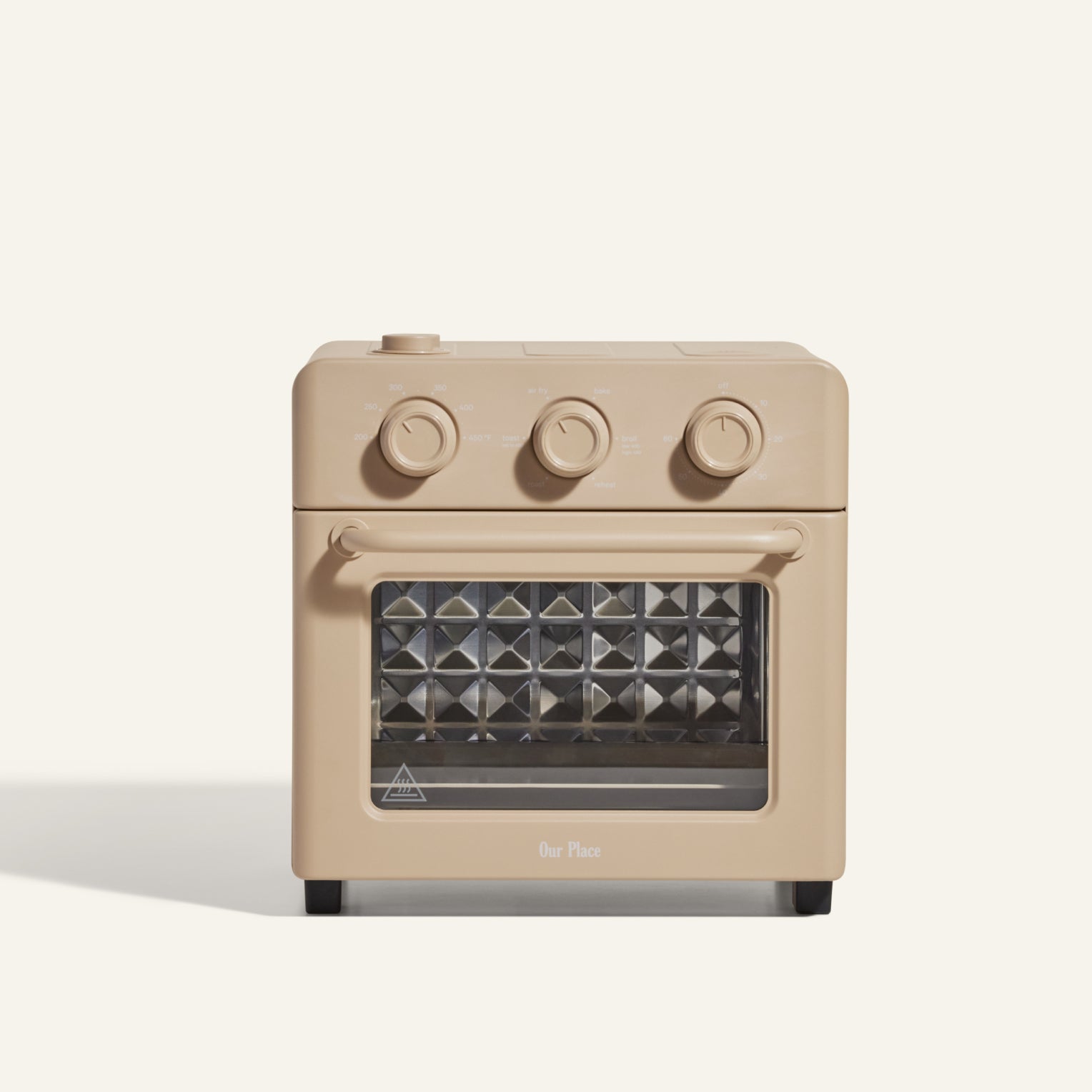 The AU - Wonder Oven is a beige toaster oven with three top control knobs, a glass front door, a diamond-patterned interior, and versatile air fryer functionality.