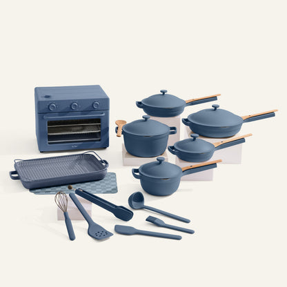 Blue kitchenware set including pots, pans, and utensils on a white background