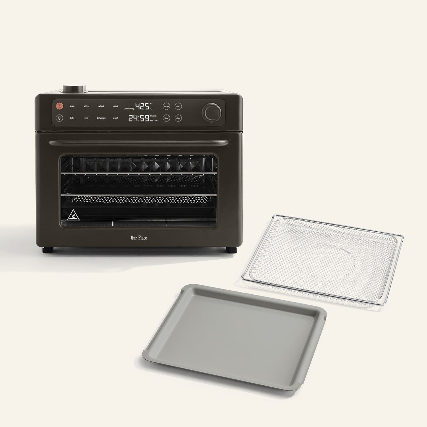 The Wonder Oven Pro + Wonder Oven Pro Essentials Kit is a black countertop air fryer oven with a digital display, shown with a wire rack and baking tray in front of it on a light background.