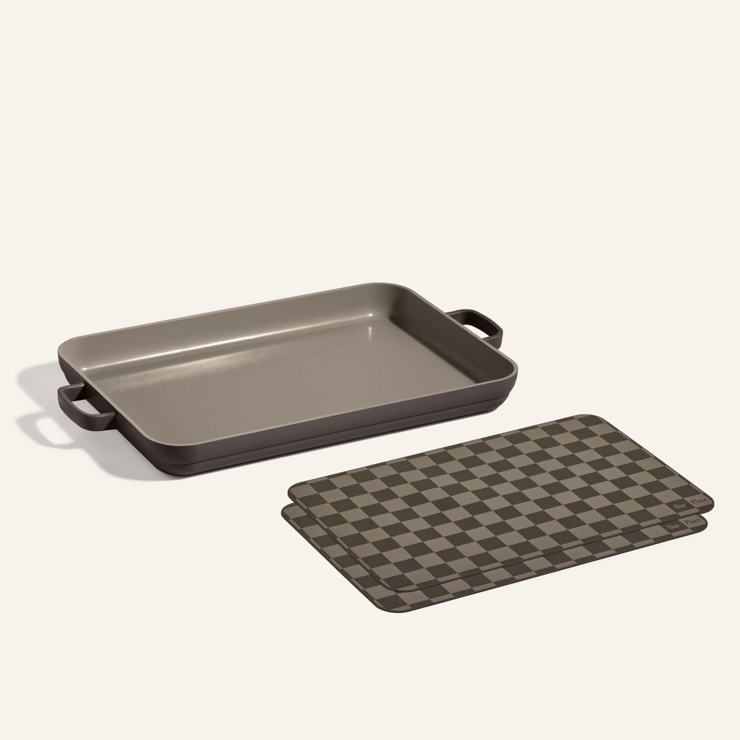 A Griddle Pan with handles sits beside two brown and black checkered Oven Mats, all displayed on a light background.