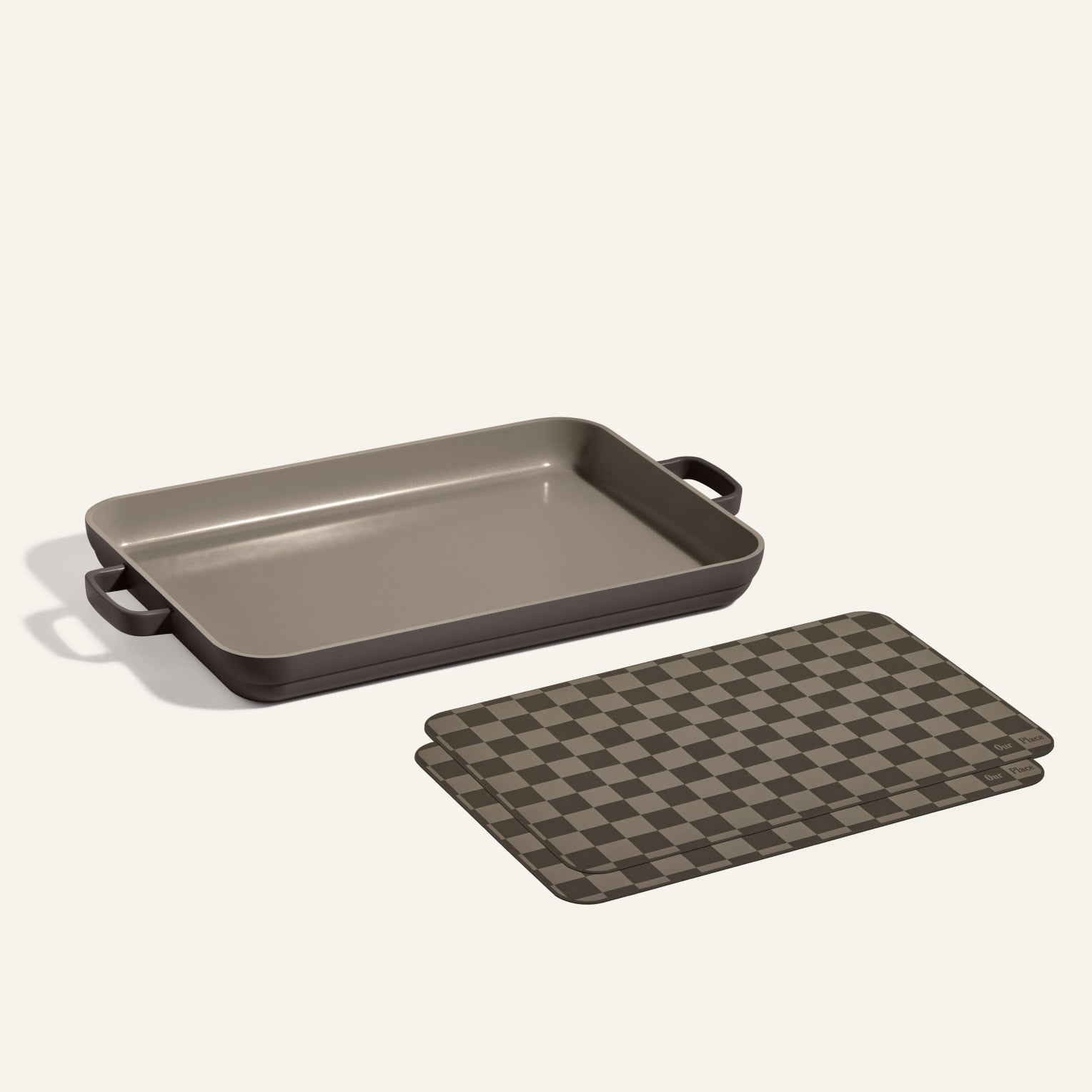 A Griddle Pan with handles sits beside two brown and black checkered Oven Mats, all displayed on a light background.
