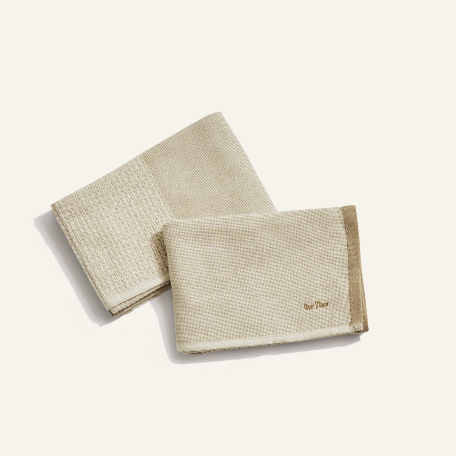 two beige dish towels on white background