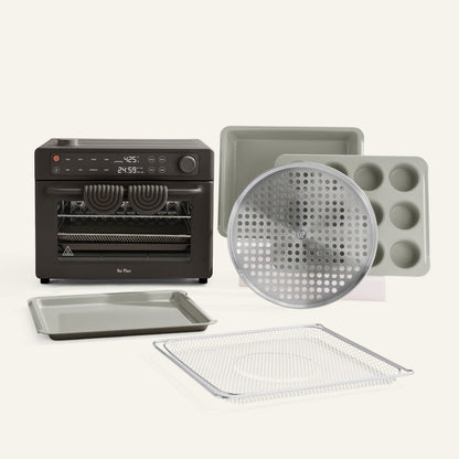Collection of kitchen baking tools including an oven, trays, and a muffin tin on a white background.