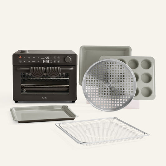 Collection of kitchen baking tools including an oven, trays, and a muffin tin on a white background.