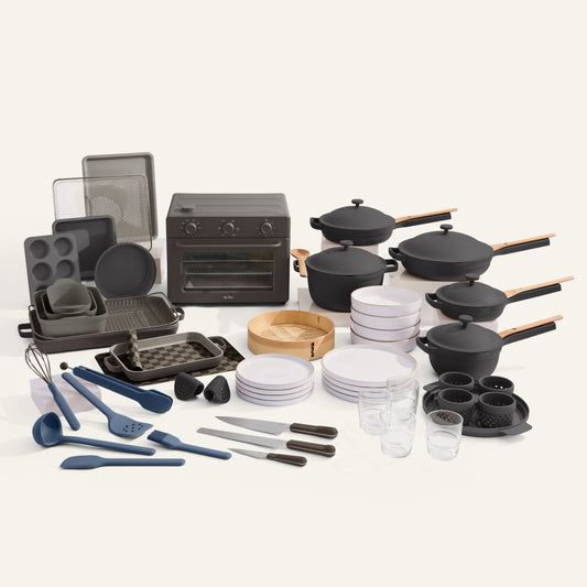 Collection of kitchenware including pots, pans, utensils, and cookware on a white background