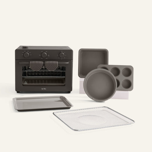 Set of black kitchen appliances and cookware on a white background