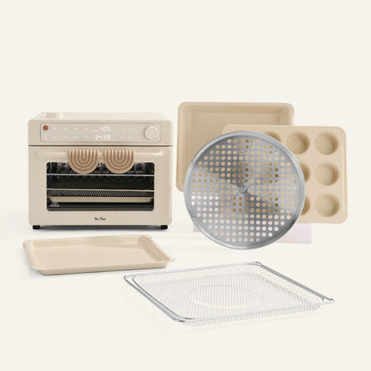 Small oven with various baking trays and accessories on a white background