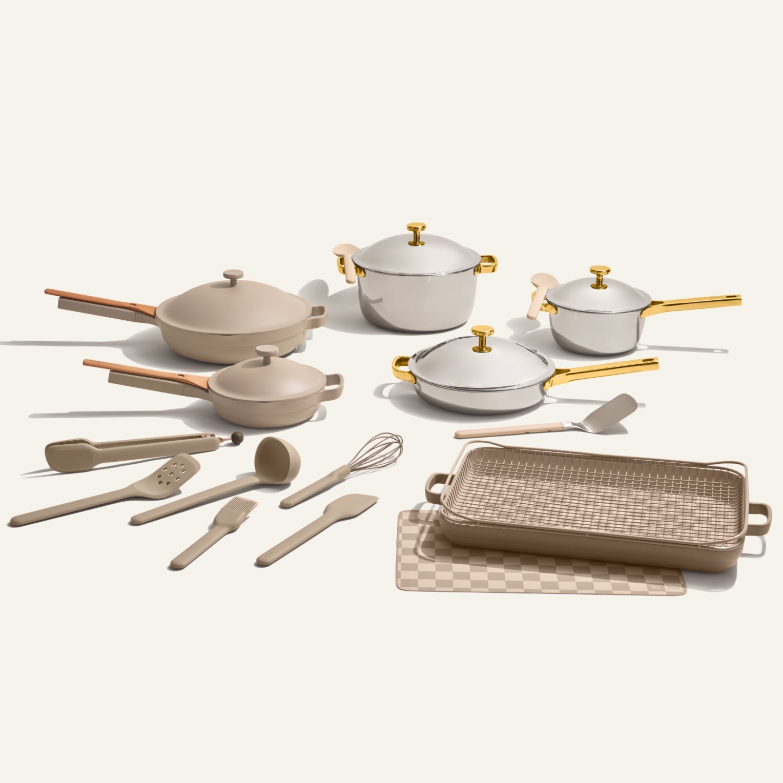 The 25-piece Home Chef Set features beige and white non-toxic cookware and utensils—pots, pans, lids, spatulas, a whisk, grill pan, and checkered trivet—arranged on a neutral background.