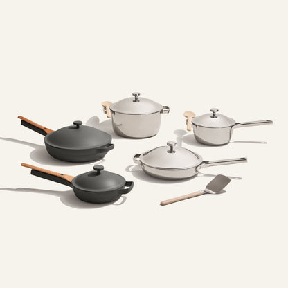 The Home Chef Set (15 piece) features two saucepans, a sauté pan, a stock pot, a frying pan, a small pot with lids, and a spatula, all arranged on a plain background.