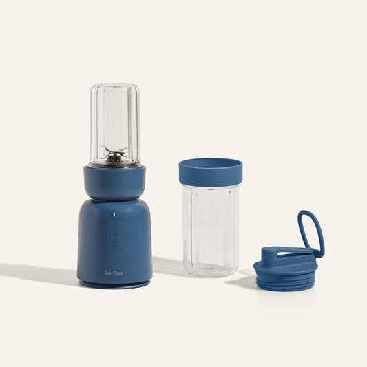The Splendor Blender and Splendor Blender Personal Kit include a blue portable blender with a clear blending cup, an extra clear cup with a blue lid, and a matching blue drinking lid, all displayed against a plain background.