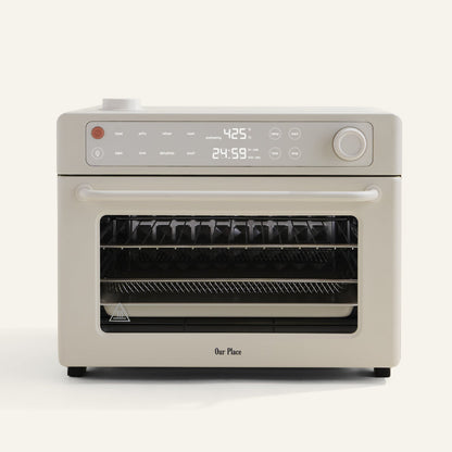 Beige oven with digital display on a white background