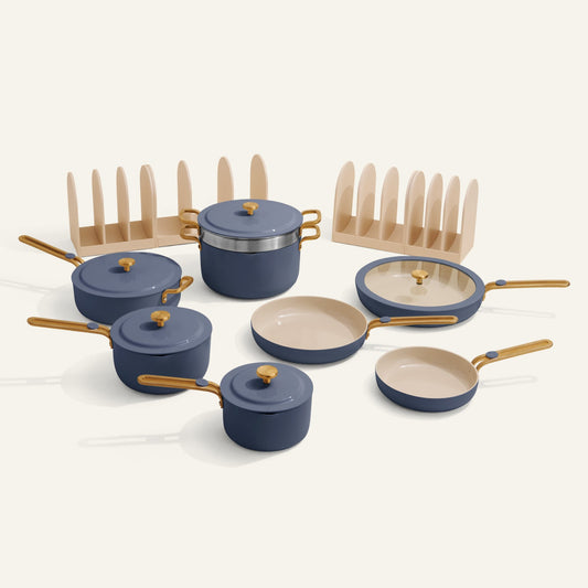 Set of blue cookware with gold handles on a white background