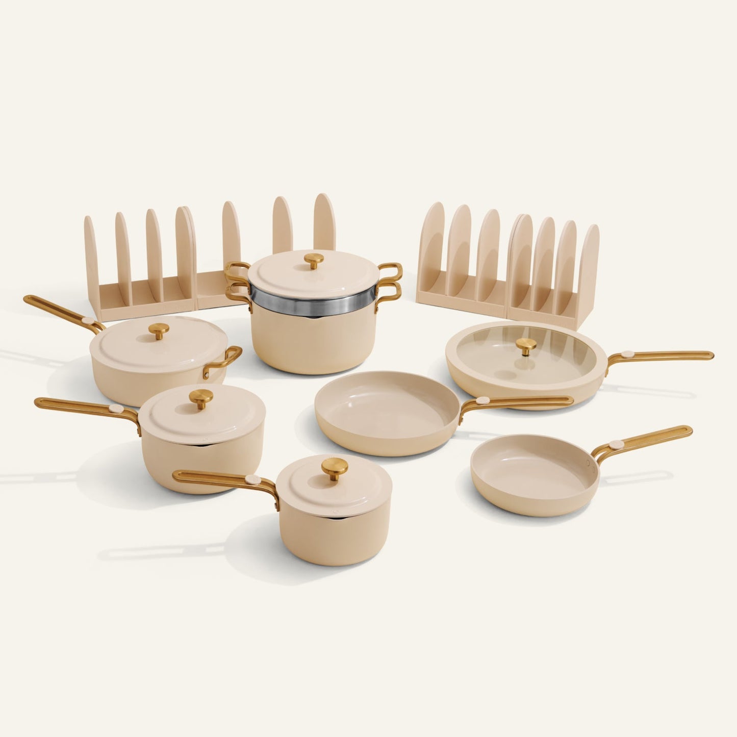 Set of ceramic cookware with gold handles on a white background
