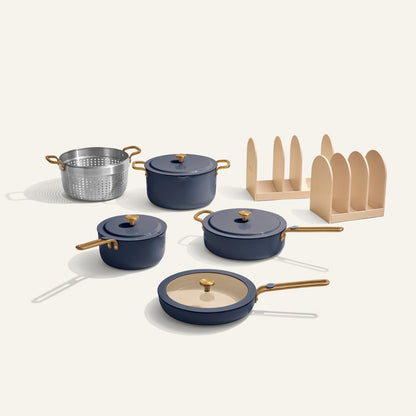 Set of blue cookware with wooden handles on a white background
