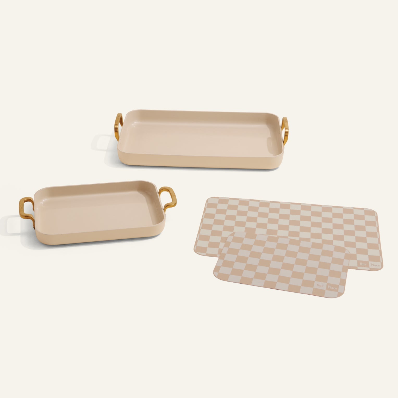 The Essentials Griddle Pan Set features two beige rectangular baking dishes with handles and two beige checker-patterned silicone mats, ideal for easy, non-toxic baking and cooking on your favorite nonstick griddle pans.