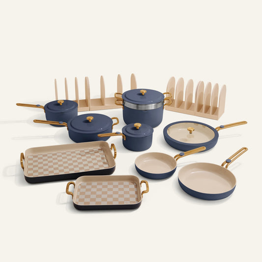 Set of blue and beige cookware with checkered trivets on a white background