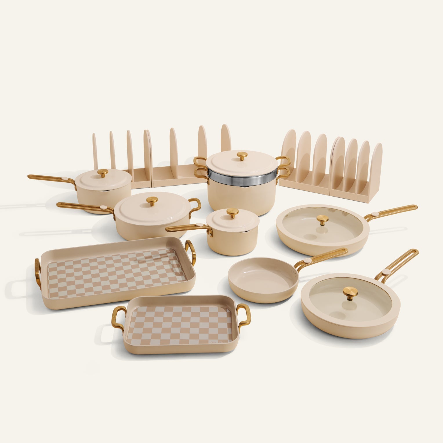 Set of ceramic cookware with gold handles on a white background
