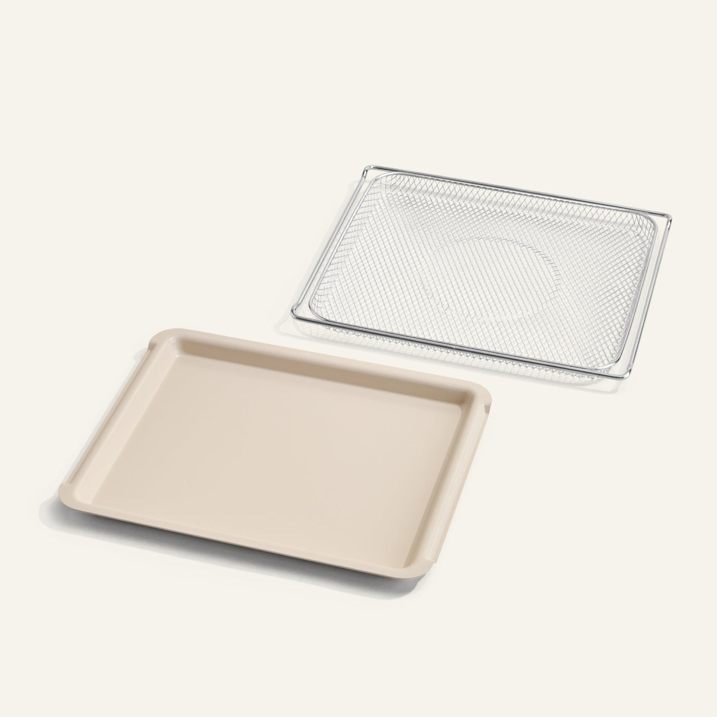 Beige baking tray with a metal mesh rack on a white background