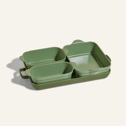 The Bakeware Set features four green ceramic dishes of different sizes, nested together on a light background—a stylish addition to any kitchen.