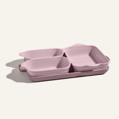 The Bakeware Set includes four pink ceramic baking dishes—two small and two large—designed for a stylish kitchen and shown neatly stacked on a light surface.