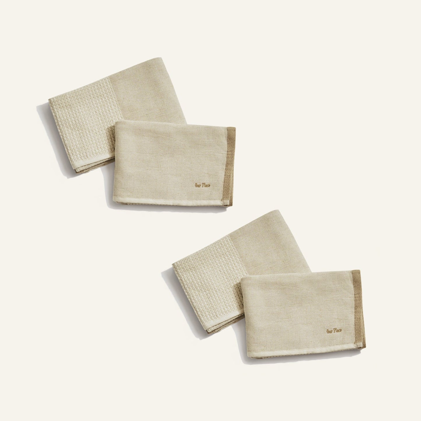 Set of beige folded towels on a white background