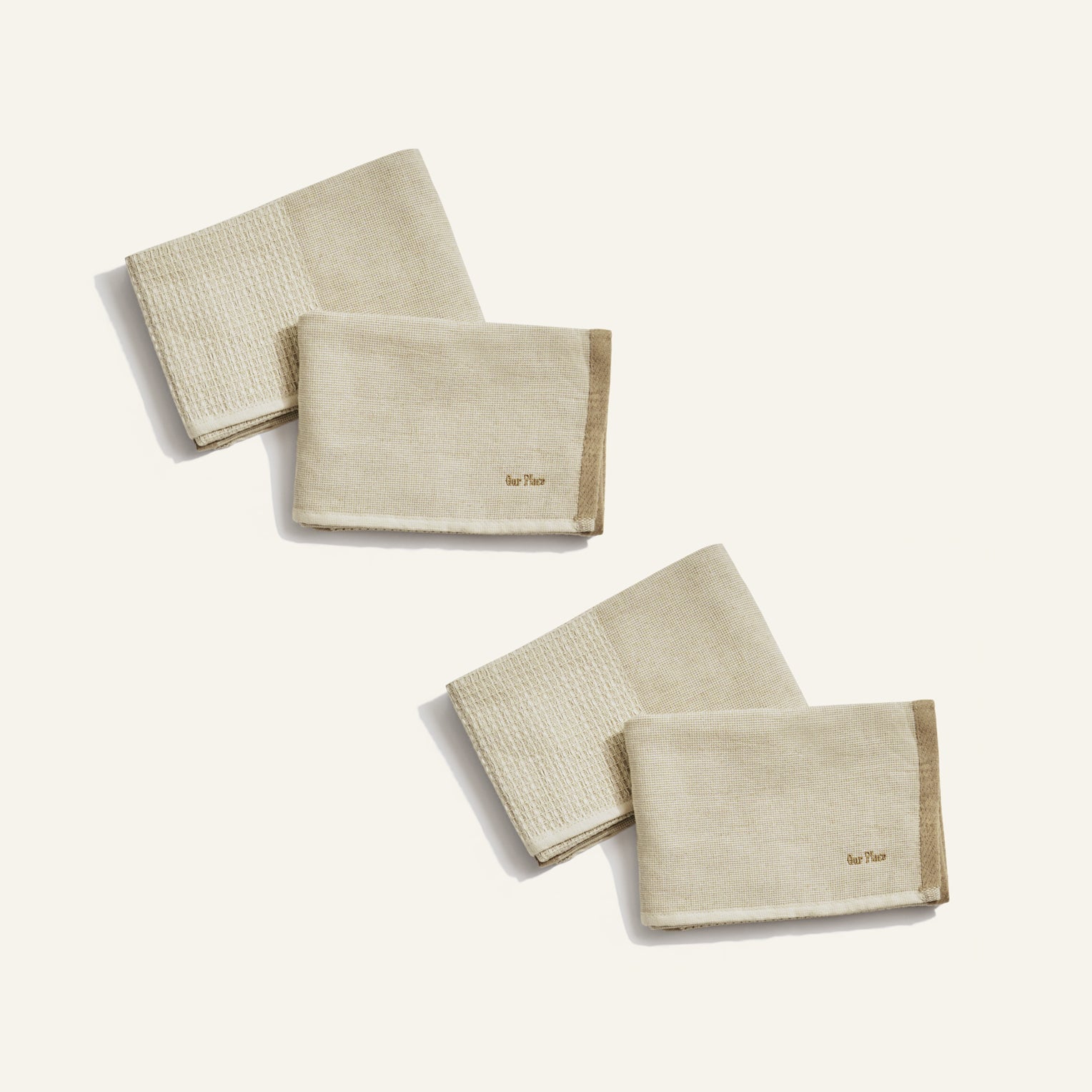 Set of beige folded towels on a white background